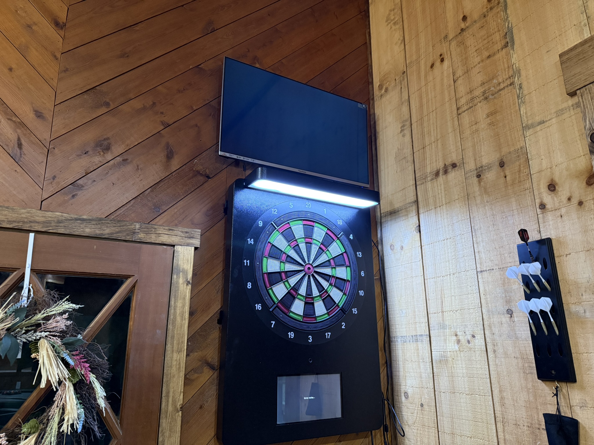 inside dart board with a television to keep track of the score
