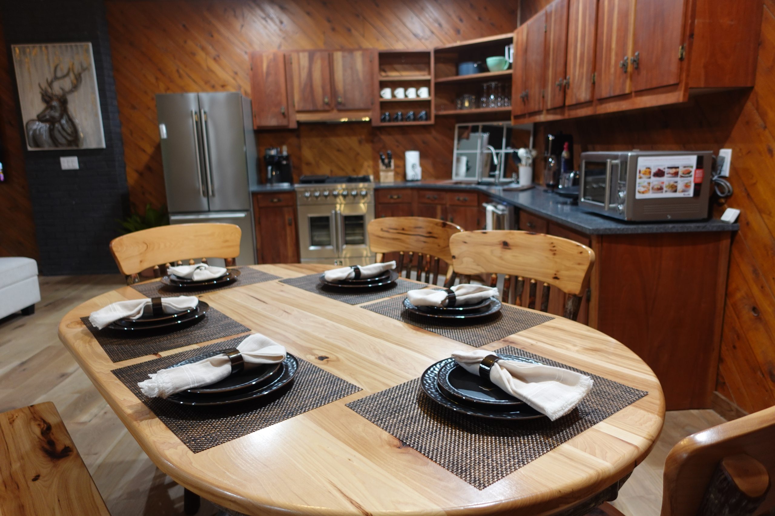 a dining room with six chairs, six plates, and six napkins made of amish wood. additional chairs are available for guests